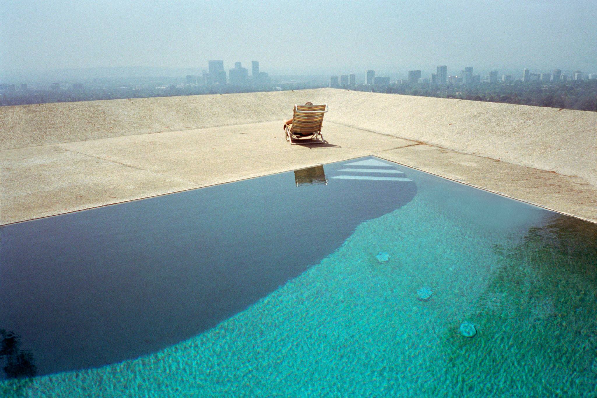 Mark Horn -Person in deckchair by pool, facing cityscape of downtown L.A..jpg