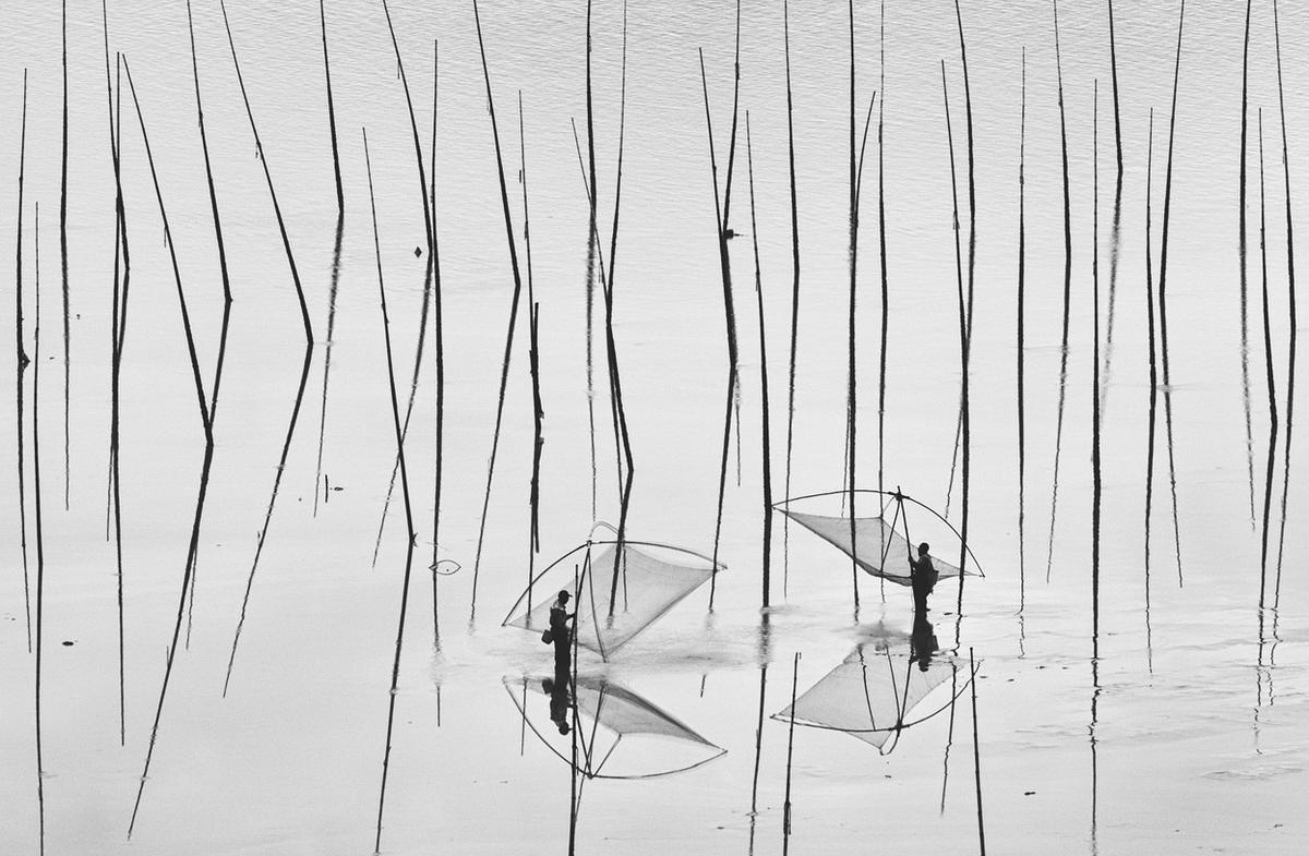 Peng Jiang. Two Fishermen. The shoal is one of the most fascinating places in Xiapu, China. 2012.jpg